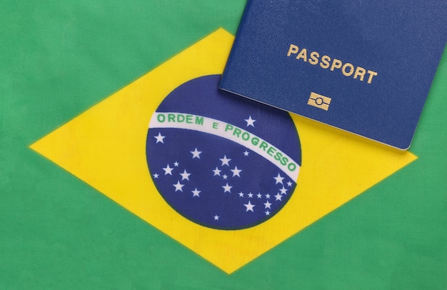 Travel concept. Passport against the background of Brazil flag