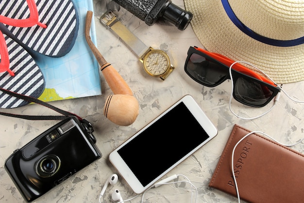 Travel concept Smartphone, passport, map, photo chamber and sunglasses. top view