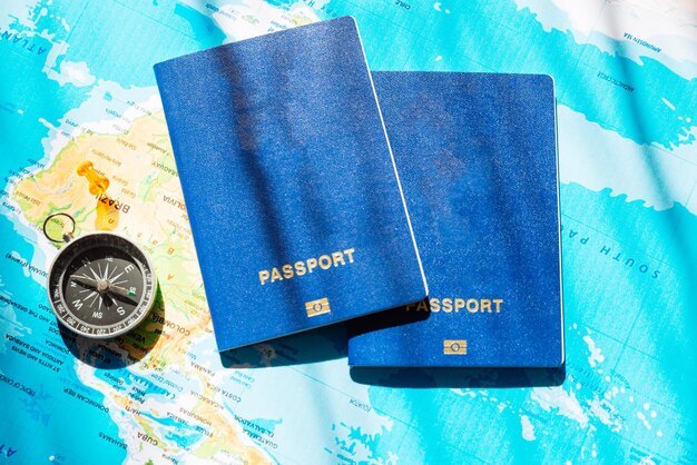 Photo travel concept two passports with compass on world map