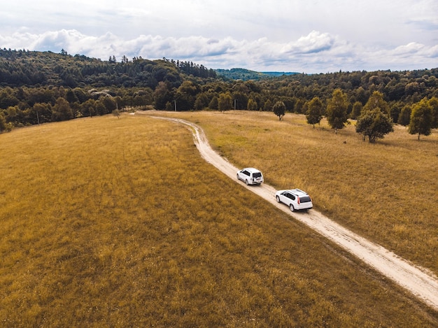 Travel concept two suv car riding by trail road