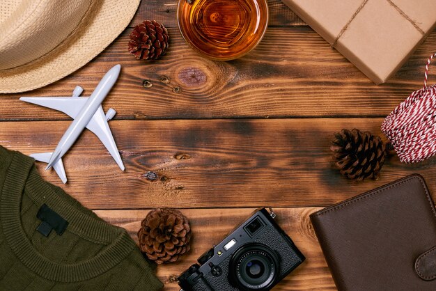 Travel concept on wooden table. Christmas decorations, camera, Vietnamese passport, clothes.