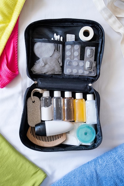 Foto kit di cosmetici da viaggio sulla vista dall'alto del letto