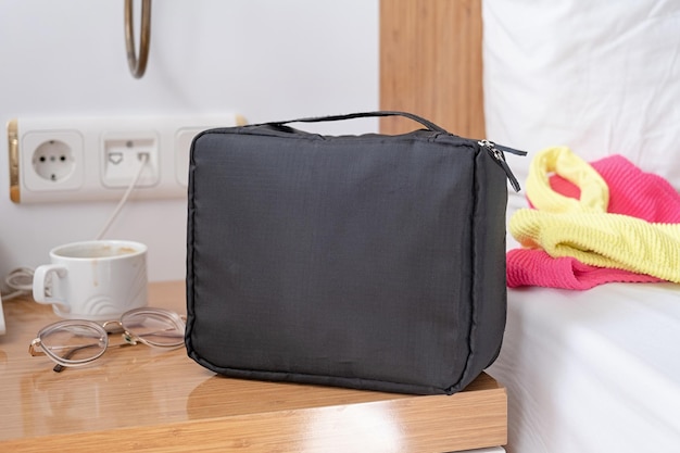 travel cosmetics kit with bottles on hotel room table front view