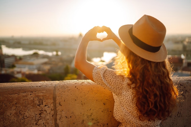 Travel in Europe Young woman enjoys sunrise The concept of travel tourism vacation and freedom