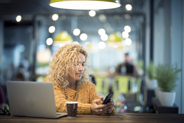 Travel and everywhee office concept with nice adult caucasian woman with technology and coffee 