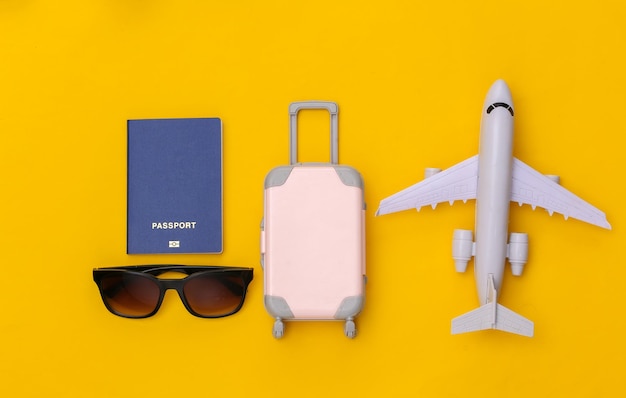 Travel flat lay. Travel accessories on yellow background. Minimal style. Top view