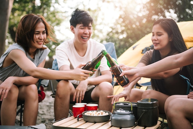 Travel group of diverse asian people enjoy camping tent with
friends hang out party summer travel and recreation concept