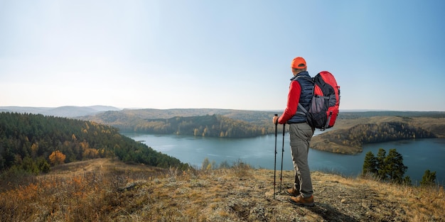 Travel hiking man hiker on trek hike with backpack hiking poles
active lifestyle people outdoor sports banner with copy space