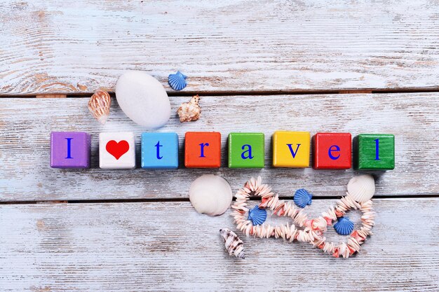 Travel inscription on wooden background