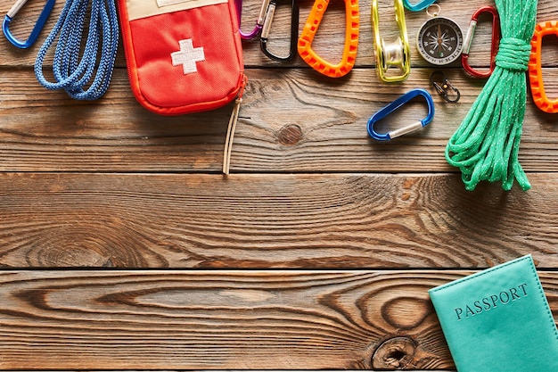 Travel items for hiking over wooden background