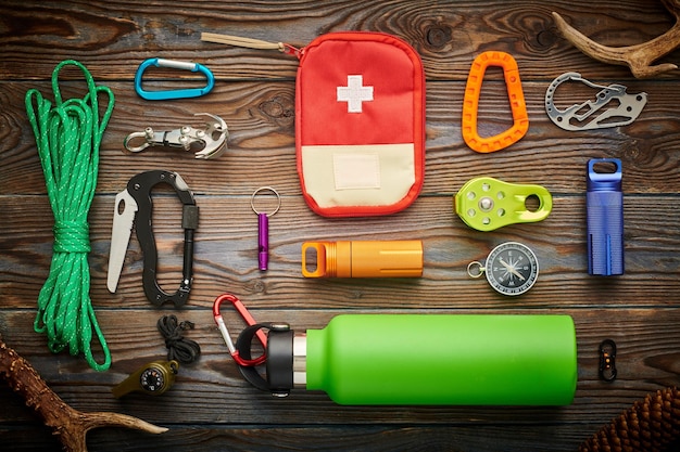 Travel items for hiking over wooden background