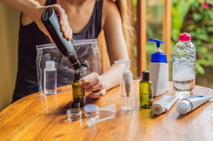 Photo travel kit for transporting cosmetics on an airplane cosmetics are ready to be poured into small bottles a woman shifts cosmetics to take with her