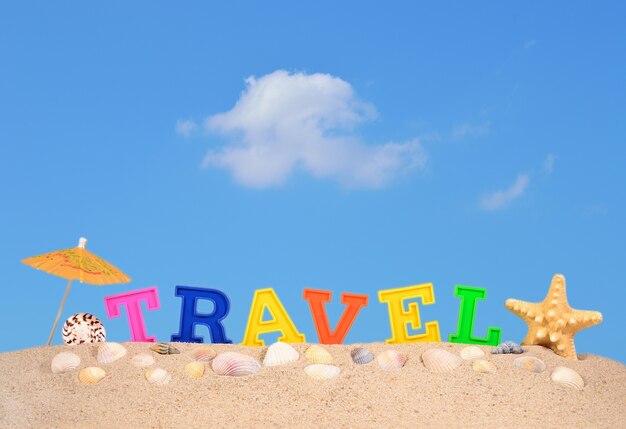 Travel letters on a beach sand