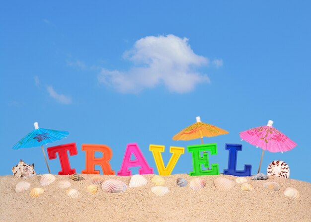 Travel letters on a beach sand