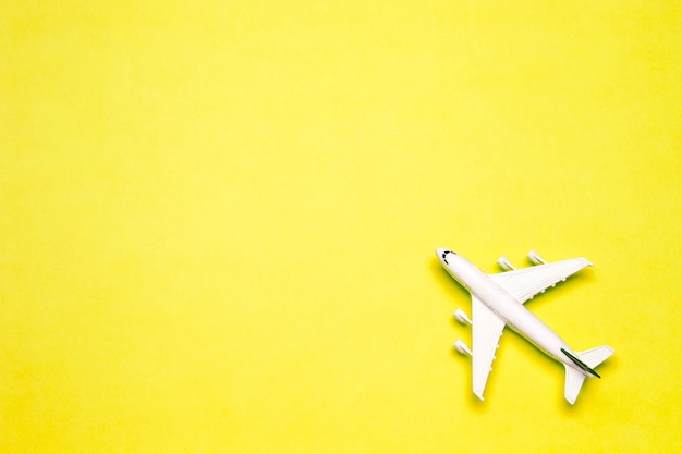 Travel minimal background. Model airplane in flight on an empty colored background. Copy space