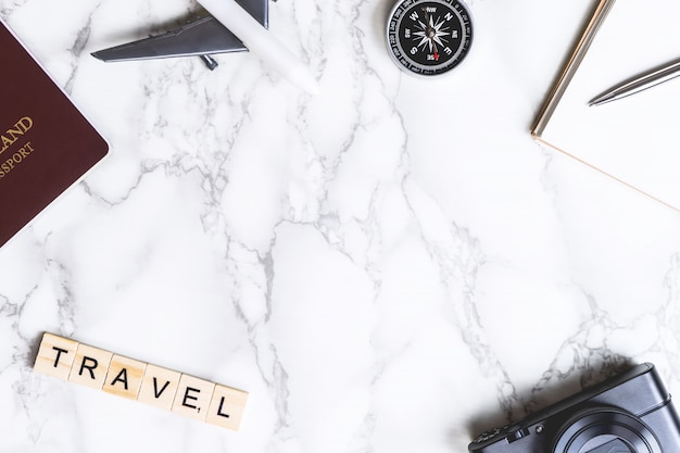 Travel objects with travel text on marble copyspace