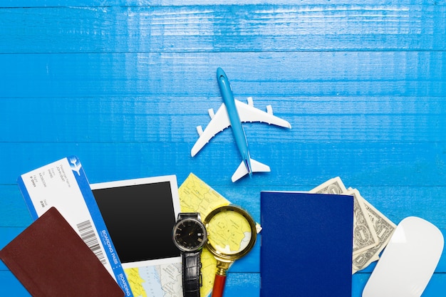 Travel objects on wooden background