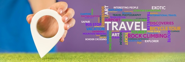 Photo travel planning gps pin symbol in hand and a word cloud on the theme of travel in different colors and sizes on a purple background banner on the theme of travel high quality photo