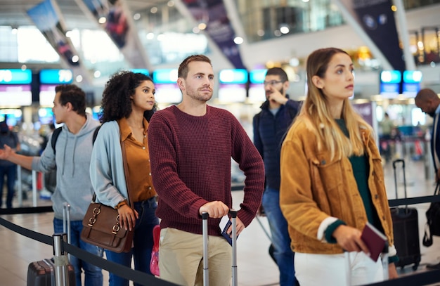 Travel queue and wait with man in airport for vacation international trip and tourism Holiday luggage and customs with passenger in line for airline ticket departure and flight transportation