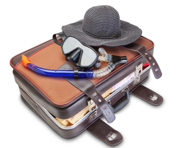 Travel set on suitcase snorkel mask Panama. On a white wall.