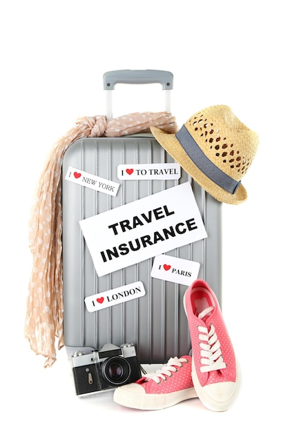 Travel suitcase and tourist stuff with inscription travel insurance isolated on white