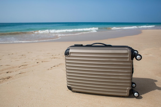 Travel on Summer and tourist planning with yellow suitcase with yellow hat fashion in the beautiful beach Travel in holiday Blue sky and sand background on travel in summer concept