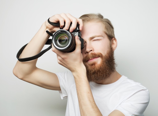 Travel technology and life style concept young bearded  photographer taking pictures with digital camera