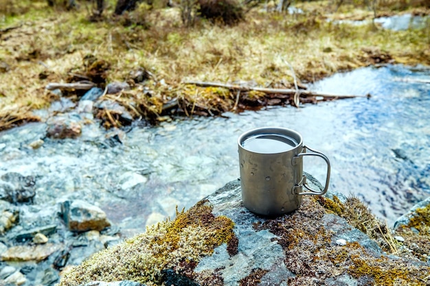 Travel titanium cup. Lunch during the journey to the wild. Camping lifestyle.