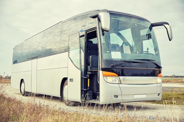 travel, tourism, road trip and passenger transport - tour bus staying outdoors