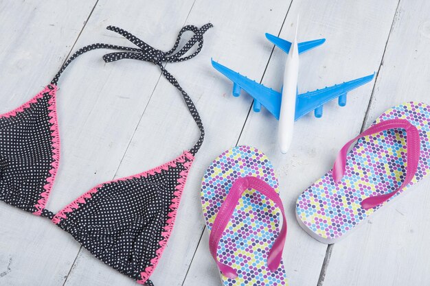 Travel and vacation concept model of airplane fashion swimsuit with flip flops in polka dots