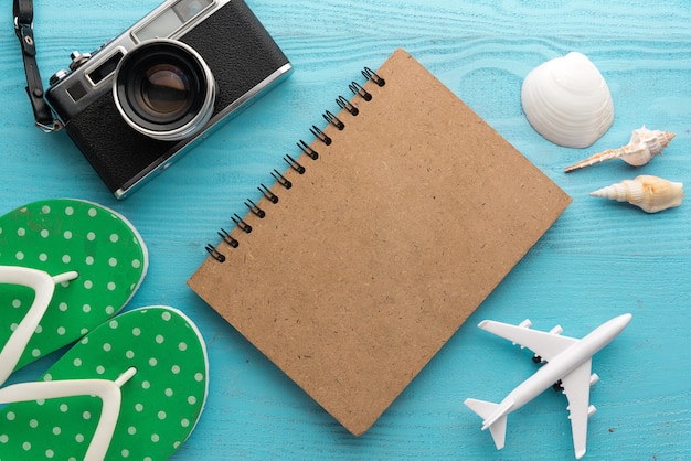 Travel and vacation items on wooden table