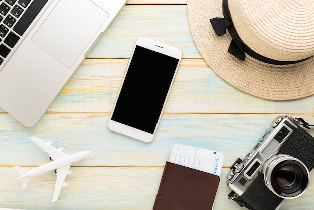 Travel and vacation items on wooden table