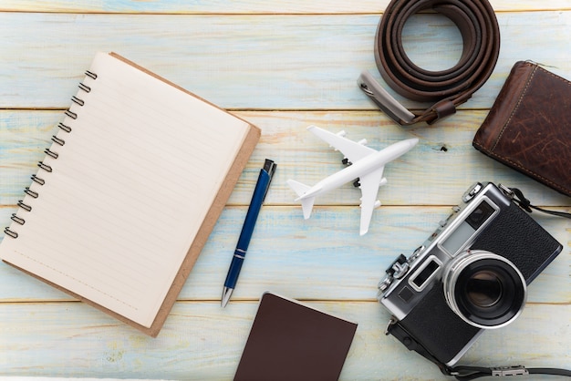 Travel and vacation items on wooden table