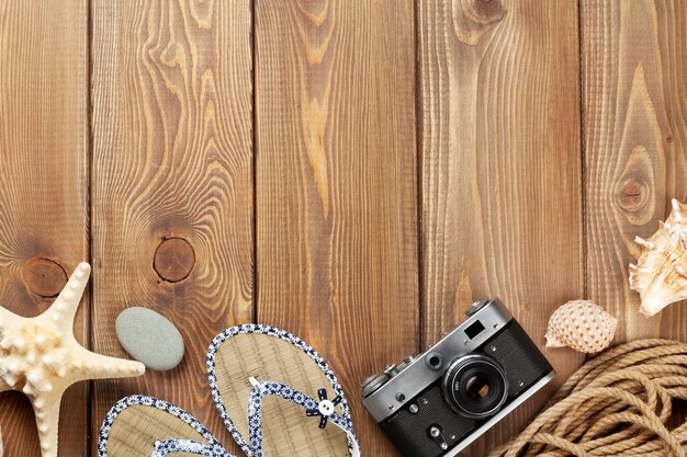 Photo travel and vacation items on wooden table