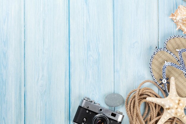 Travel and vacation items on wooden table