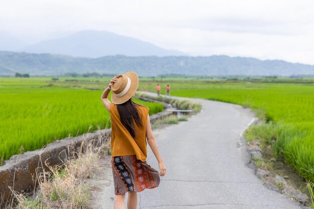 Travel woman enjoy the rice field scenery view in countryside