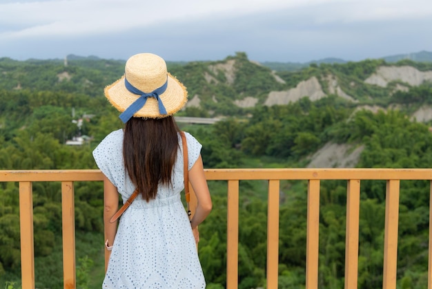 Travel woman go badlands geological landscape of Tianliao moon world in Kaohsiung Taiwan