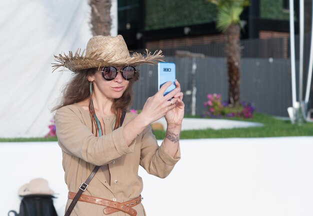 Travel woman in straw hat take a selfie photo