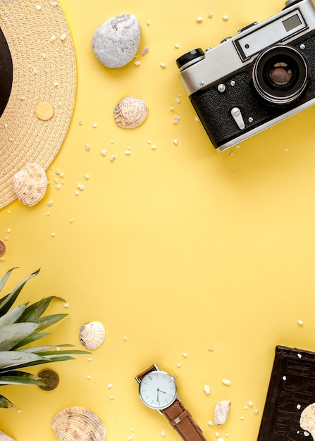 Traveler accessories tropical palm leaf branches on yellow background with empty space for text summ