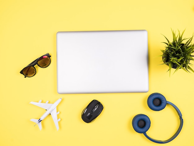 Traveler businessman  laptop top view on wooden desk , sunglasses, headphones