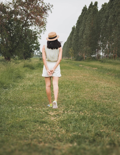 Traveler girl walking in the garden background with vintage filter