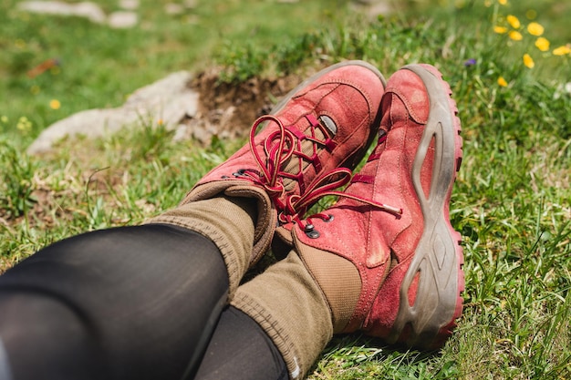 Traveler hiking red boots on beautiful mountain landscape view.\
tourism or freedom concept. legs of traveler sitting making feet\
selfie on a high mountain in travel.