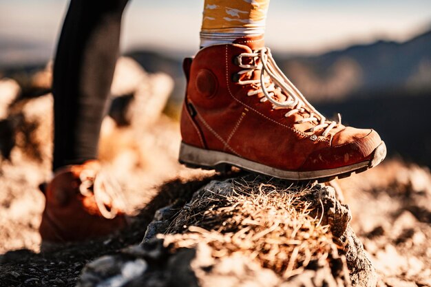 Traveler hiking with backpacks hiking in mountains sunny\
landscape tourist boots having fun and enjoying wonderful\
breathtaking mountain view