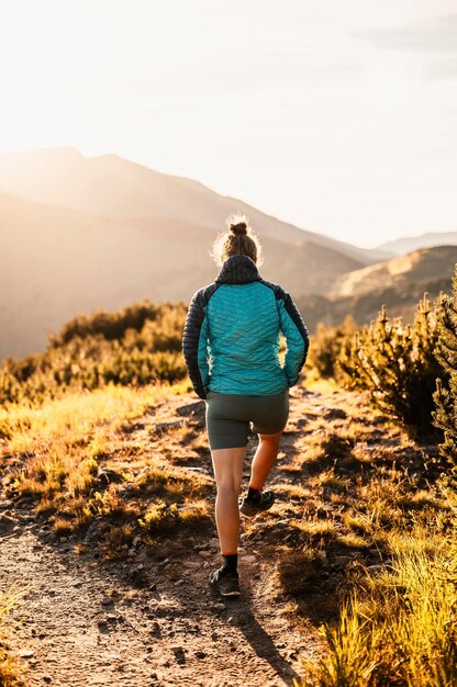 Traveler hiking with backpacks hiking in mountains sunny\
landscape tourist traveler on background view mockup high tatras\
slovakia