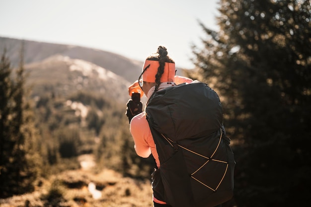 Traveler hiking with backpacks hiking in mountains sunny\
landscape tourist traveler on background view mockup high tatras\
slovakia