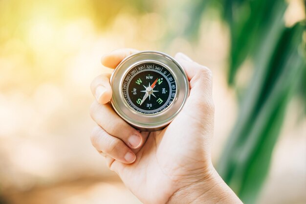 Traveler holds a compass in a park finding her way amidst confusion The compass in her hand symbolizes guidance exploration and the journey to conquer defeat