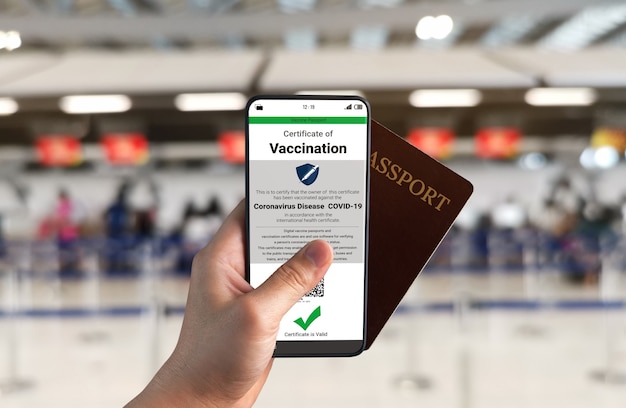 Traveler holds vaccine passport certificate