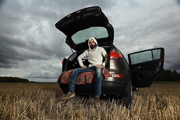 Photo traveler in a jeep sky clouds autumn