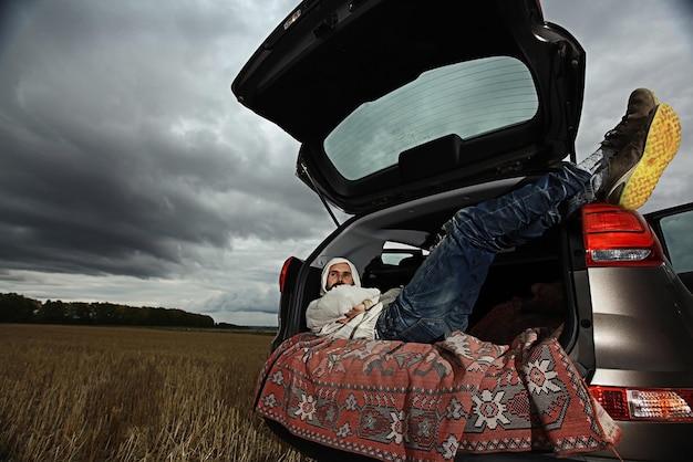 Photo traveler in a jeep sky clouds autumn