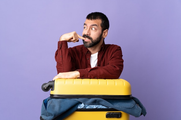 Traveler man packing suitcase